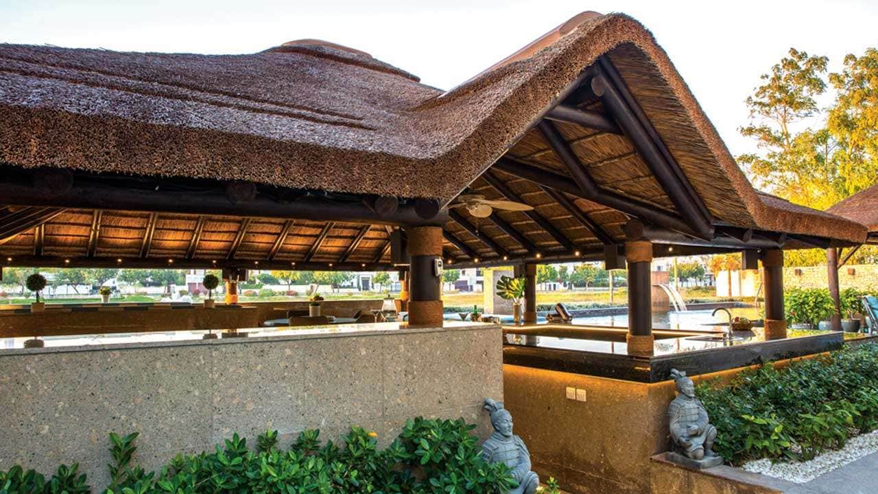 Thatched outdoor entertainment area with gabled entrance