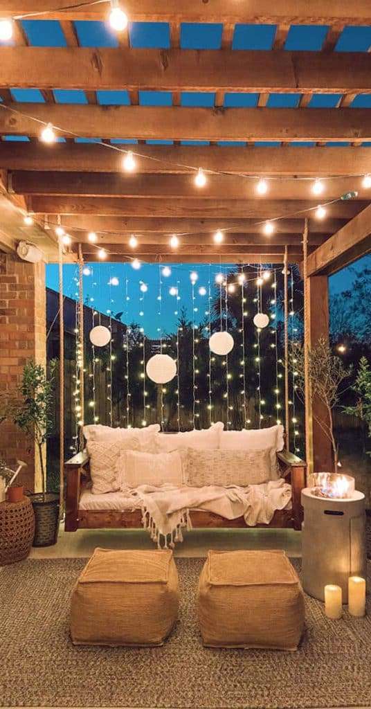 Square timber pergola with swing and lighting