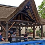 Luxurious thatched gazebo in Arabian Ranches, Dubai, surrounded by lush greenery.