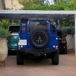 Timber pergola carport shading luxury vehicles in the UAE.